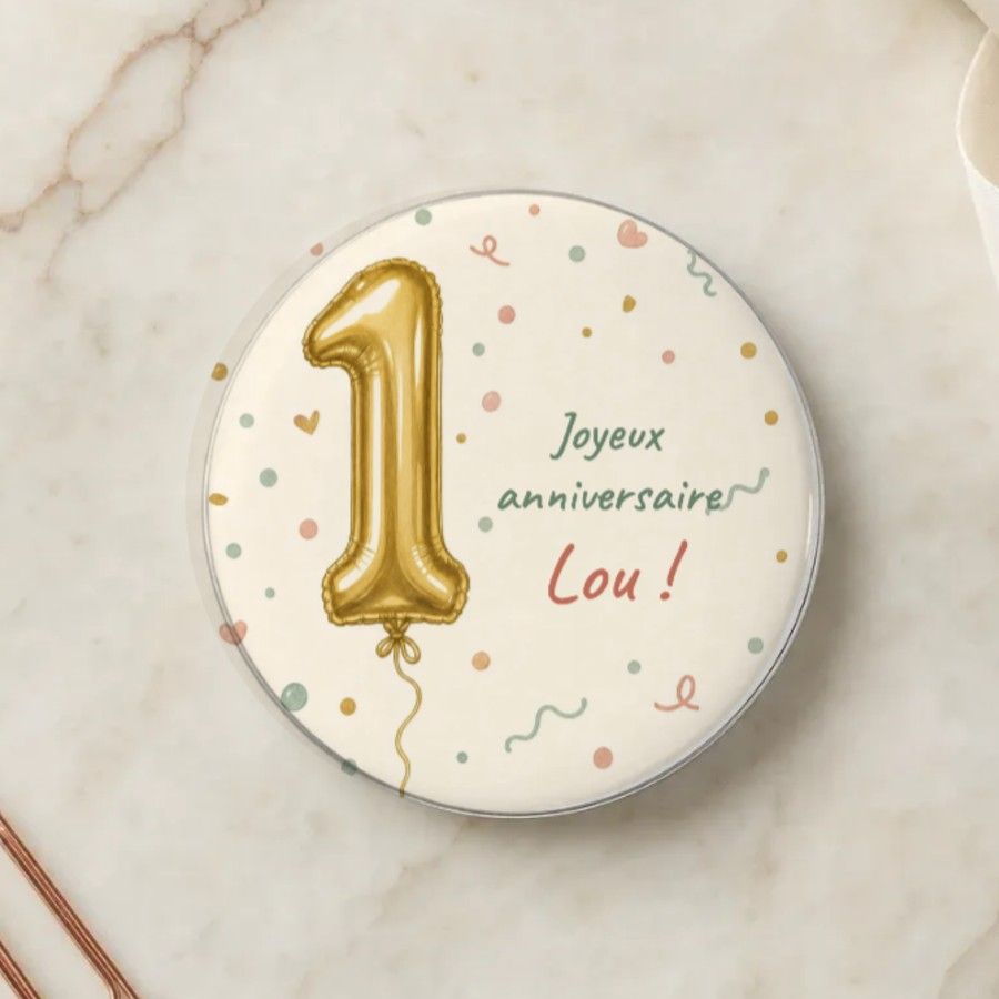 Magnet rond du premier anniversaire : un ballon doré en forme de 1 et des confettis