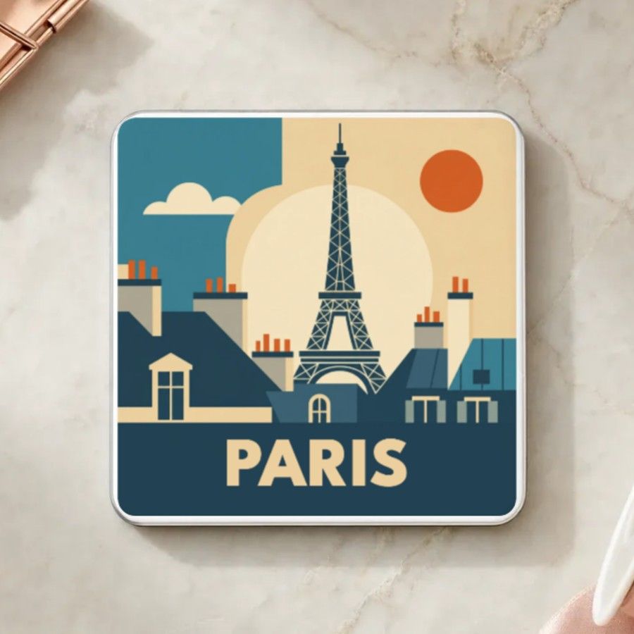 Magnet souvenir de Paris en style géométrique années 50 : la tour Eiffel, les toits en zinc et leurs cheminées sous un soleil orange, nom en grandes capitales